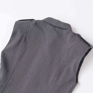 Deep grey sleeveless double-breasted vest dress with notched lapels and epaulettes
