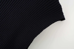 Detailed macro view of the navy blue rib-knit fabric texture and stitching on the tank top