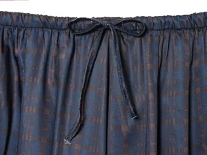 Close-up of elastic waistband with drawstring on navy blue vintage jacquard pants