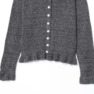 Chic grey knit cardigan with white buttons and layered ruffle hem details