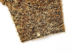 Detail of metallic gold thread bomber jacket featuring a shiny metal snap button closure