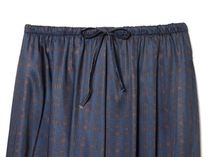Detail of dark blue jacquard trousers showing elastic waistband and drawstring bow tie