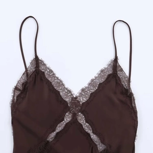 Detail of eyelash lace trim and silky satin fabric on a dark coffee V-neck camisole