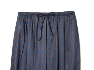 Detailed macro of deep blue jacquard lantern pants with elastic waist and drawstring tie
