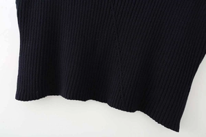 Detailed close-up of dark blue ribbed knit fabric texture and hem finish for tank top