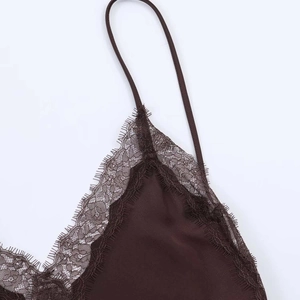 Close-up of silky brown midi dress with delicate eyelash lace trim and thin straps