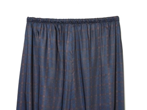 Detail of vintage navy blue plaid elastic waistband with refined pleats and fabric texture