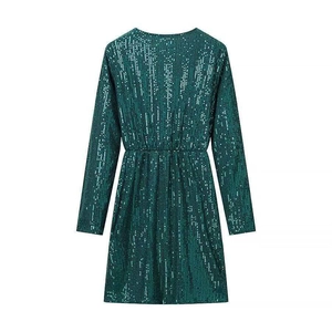 Detail view of dark green sequin long sleeve mini dress showing fabric texture and waist pleats