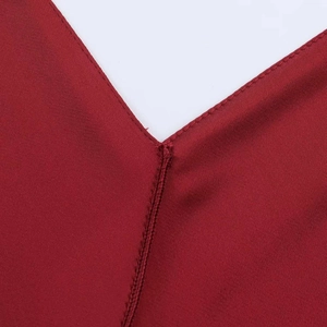 Detailed close-up of the V-neckline and stitching on this elegant satin midi dress