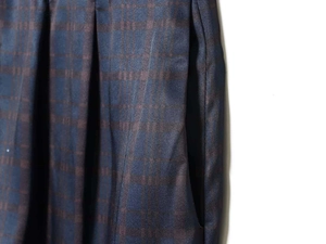 Close-up of deep blue jacquard lantern pants featuring box pleats and side pockets