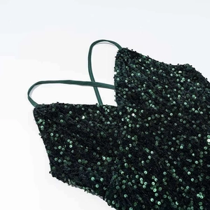 Sparkly dark green sequin mini dress with thin shoulder straps for a glamorous party look