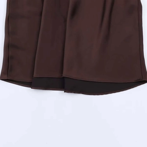 Detail shot of dark brown satin fabric showing silky texture and elegant drape of the dress