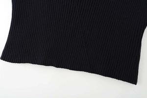 Macro shot of dark navy ribbed knit fabric detailing neat seams and textile texture
