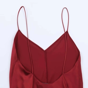Detail of elegant burgundy satin midi dress showing V-neckline and slim spaghetti straps