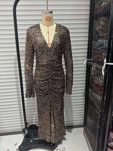Detailed view of bronze sequined evening dress with deep V-neck and ruched waist