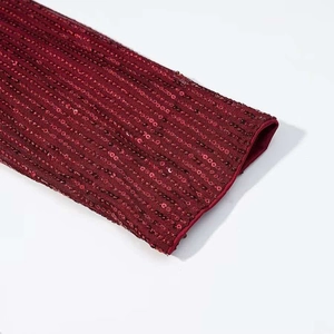 Detail of dark red sequin dress showing deep burgundy sequins sewn in vertical stripes