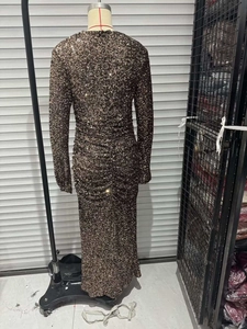 Close-up of the shimmering brown sequins and metallic texture on a slim-fit evening dress