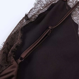 Close-up of adjustable straps and delicate eyelash lace trim on a satin midi dress