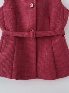 Primo piano del gilet in tweed fucsia con bottoni metallici e dettagli intrecciati
