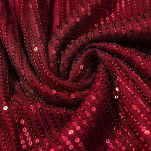 Close-up of deep burgundy sequins on mesh fabric with elegant vertical stripe pattern