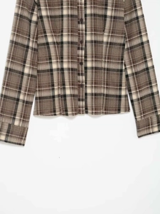 Detailed view of plaid shirt sleeves and buttons with classic check pattern