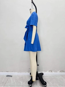 Royal blue short sleeve A-line dress with waist tie and textured fabric on a mannequin
