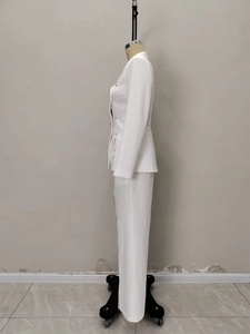 Detail view of white suit jacket with decorative metallic buttons on the side profile