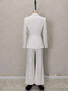 Rear view of elegant white slim-fit blazer and wide-leg trousers two-piece set for women