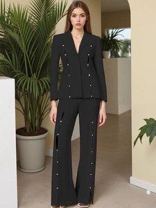 Women's black slim blazer set with vertical cutouts and decorative silver metal studs