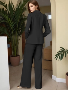 Detailed view of high-quality black tailored blazer suit with back slit and wide-leg pants
