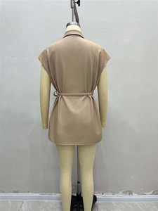 Detail view of khaki PU leather vest back with adjustable waist belt on a yellow mannequin