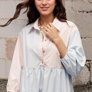 Detailed close-up of striped patchwork shirt dress with pleated waist and collar
