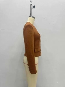 Detail of brown faux suede jacket featuring golden buttons and structured side pockets