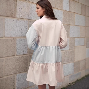 Detail of pink and blue color-block striped shirt dress with tiered skirt and lantern sleeves
