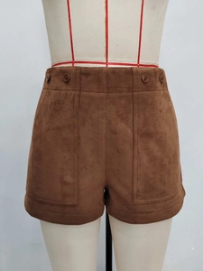 Brown high-waisted suede shorts with double buttons and pockets in a straight-cut style