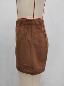 Detail view of brown faux suede shorts with high waist, side buttons and side pockets