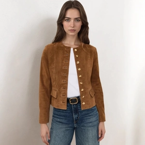 Detail view of brown suede cropped jacket with gold buttons and flap pockets