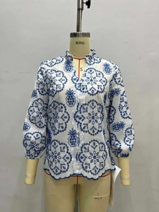 Women's white cotton blouse with blue floral embroidery, stand collar and ruffles