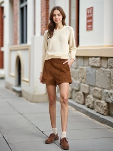 Women's autumn outfit with ivory knit sweater and brown high-waist straight shorts