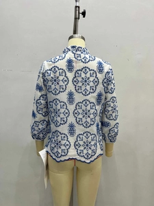 Women's white cotton blouse with blue floral embroidery and stylish stand-up collar