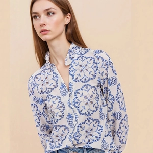 Detail of ruffle stand collar and blue mandala pineapple print on white shirt
