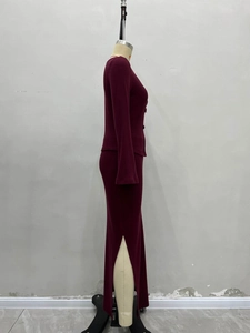 Close-up of burgundy knit set with button details and high-slit bodycon skirt texture