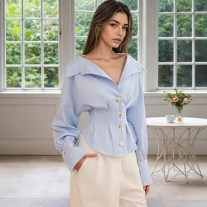 Detail of blue striped shirt showing large lapels, V-neck, and wooden button accents