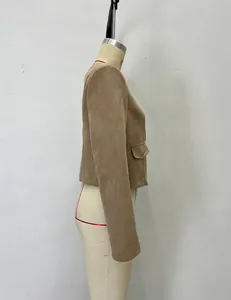 Detail view of camel suede jacket showing the pocket with a gold button and slim cut