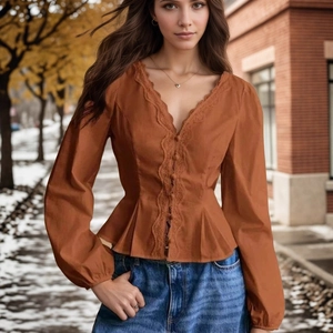 Detail of caramel lace-trim long sleeve blouse featuring V-neck and peplum waist design