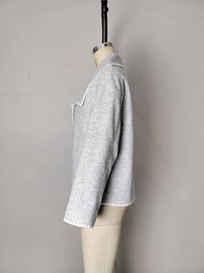 Detail view of the white wavy stitched edges on grey wool blend short cardigan jacket