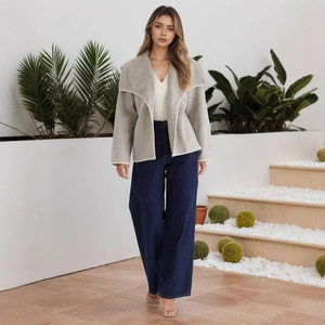 Chic light gray jacket with white woven trim over white V-neck top and wide-leg jeans