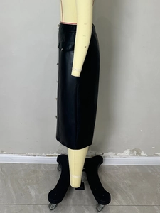 Detail view of black PU leather midi skirt featuring side buttons and pocket flap design