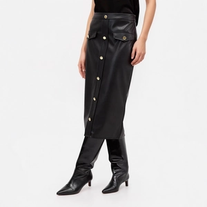 Detail of black faux leather midi skirt featuring decorative gold buttons and flap pockets