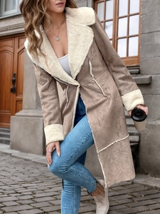 Détail d'un manteau d'hiver en suédine avec col en peau de mouton et surpiqûres